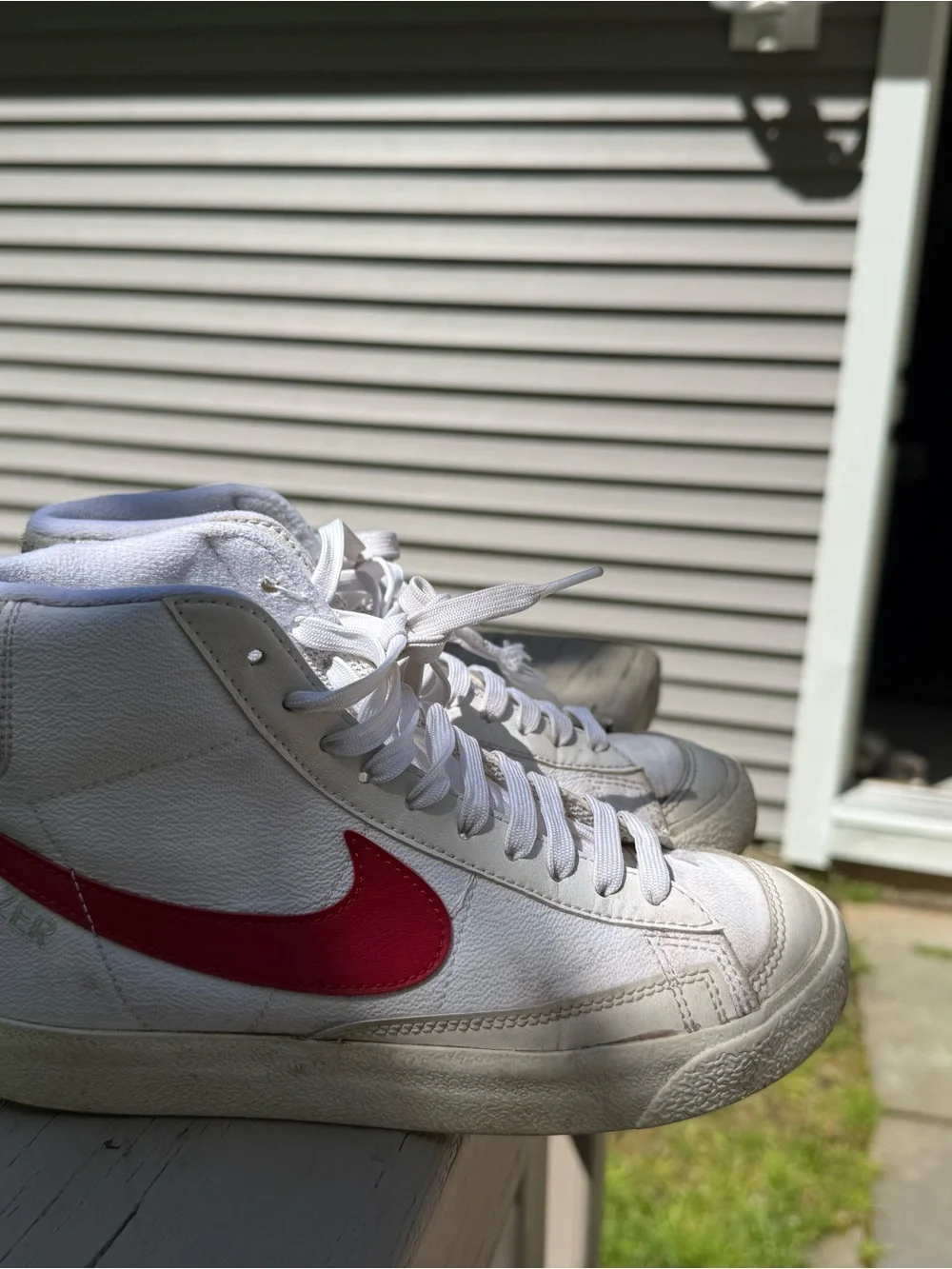 Nike White High-Top Sneakers with Red Swoosh Accent
